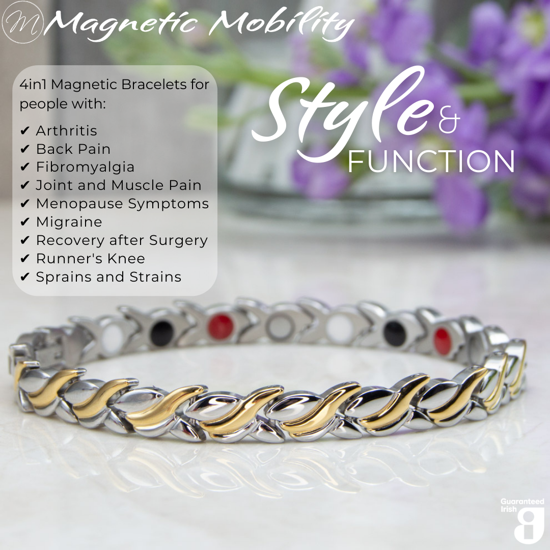 45 degree view of the Virginia moon 4in1 Magnetic Bracelet from Magnetic Mobility. Features and intricate Silver and Gold twist with the 4in1 elements hidden in the back. Perfect for people with arthritis, back pain, fibromyalgia, joint and muscle pain, menopause symptoms, migraine and more. The bracelet is shown on a reflective surface with purple flowers behind it and a white gift box. Features the Guaranteed Irish logo.