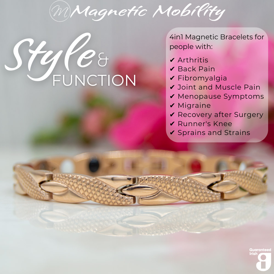 Front view of the Snapdragon Dawn 4in1 Magnetic Bracelet, rose gold coloured bracelet with snakeskin type designs, designed for pain relief, featuring various therapeutic elements. The bracelet is shown on a reflective surface with a pink flower behind it.