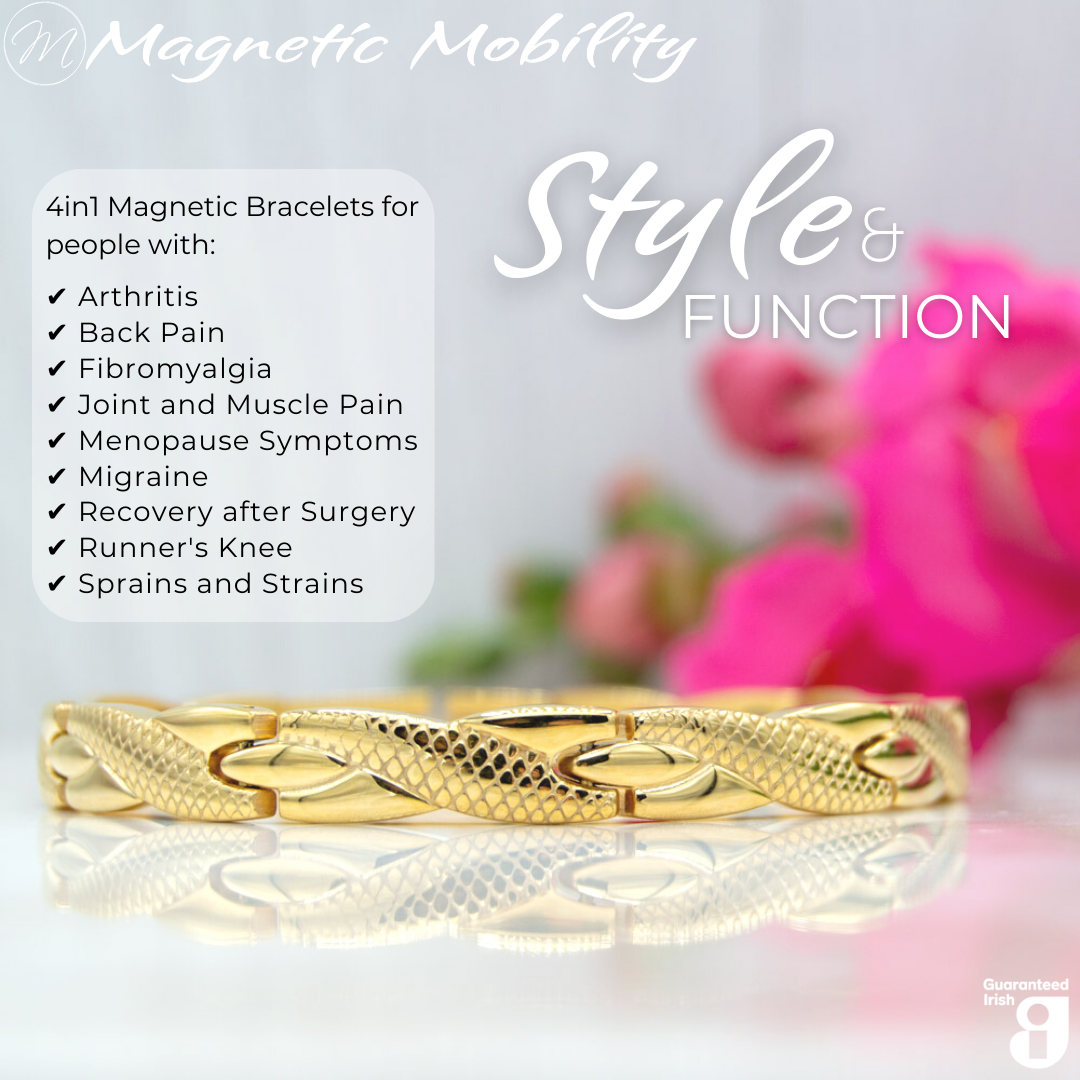 Front view of the Snapdragon Sun 4in1 Magnetic bracelet from Magnetic Mobility on a reflective surface. The bracelet is designed for people with arthritis, back pain, fibromyalgia, joint and muscle pain, menopause symptoms, migraine and more. Pink flowers are shown behind the bracelet.