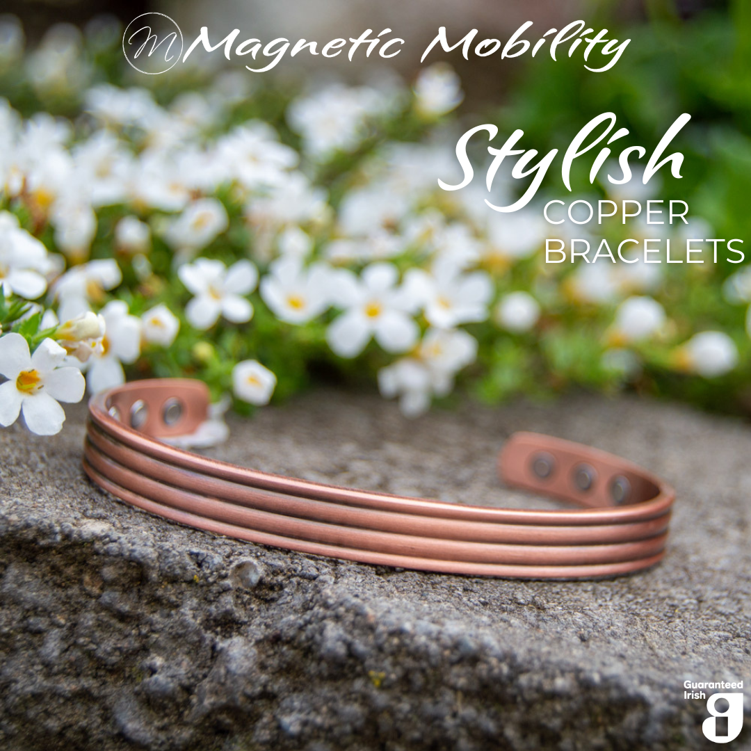 Close up view of the 3 neodymium magnets on 1 side of the heath copper bracelet from Magnetic Mobility. The copper bracelet is featured on a stone surface in a garden signifying its popularity among gardeners for helping combat aches and pains. Text states " Stylish Copper Bracelets" and the image features the Guaranteed Irish Logo.