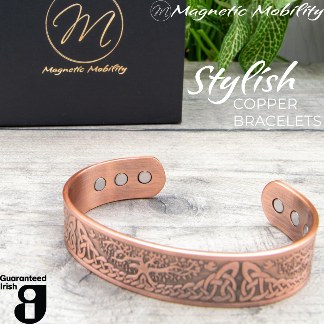 45 degree view of the Buckthorn Copper Bracelet from Magentic Mobility. A celtic tree of life design features on the front of this copper bracelet and the strong neodynimum magnetis can be seen in the back of the open bangle.