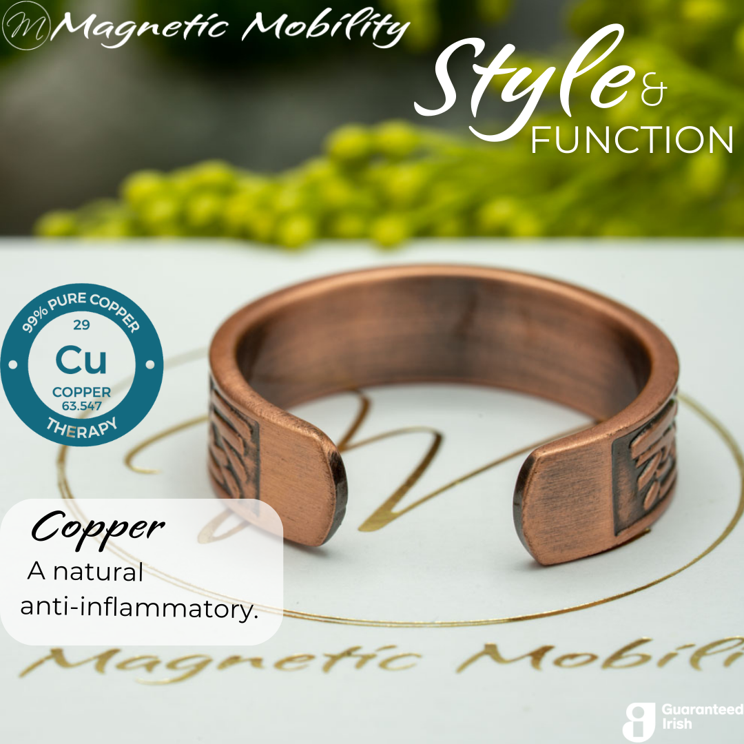Back view of the clover copper ring from Magnetic Mobility. Shown on a white gift box with green plants in the background. The writing says "Style and Function" and shows a Guaranteed irish logo.