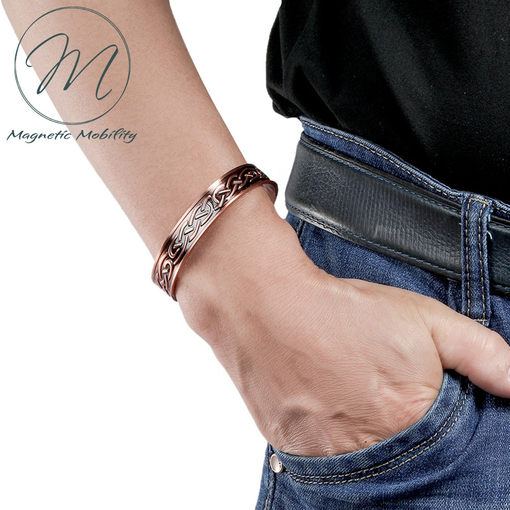 View of the Trefoil Copper bracelet from Magnetic Mobility on a wrist.