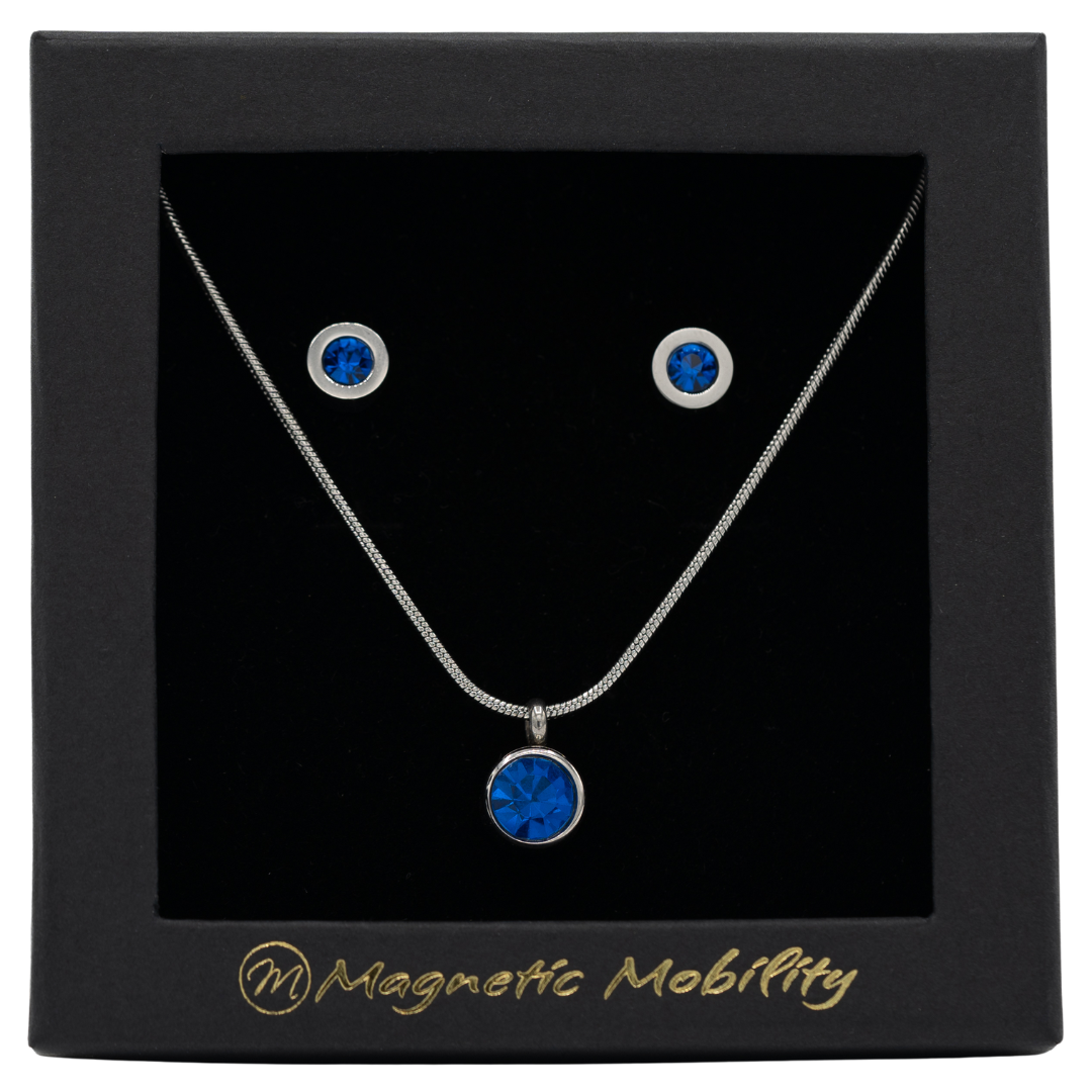 December Magnetic Mobility Birthstone Gift Set featuring a Magnetic Necklace and Stud Earrings featuring Blue Swarovski crystals, elegantly presented in a black box with Magnetic Mobility branding. These magnetic back earrings offer stylish pain relief.