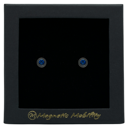Magnetic Mobility December Birthstone Stud Earrings featuring blue Swarovski crystals, elegantly presented in a black box with Magnetic Mobility branding. These magnetic back earrings offer stylish pain relief.