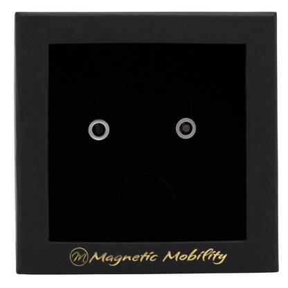 Magnetic Mobility February Birthstone Stud Earrings featuring amethyst Swarovski crystals, elegantly presented in a black box with Magnetic Mobility branding. These magnetic back earrings offer stylish pain relief.