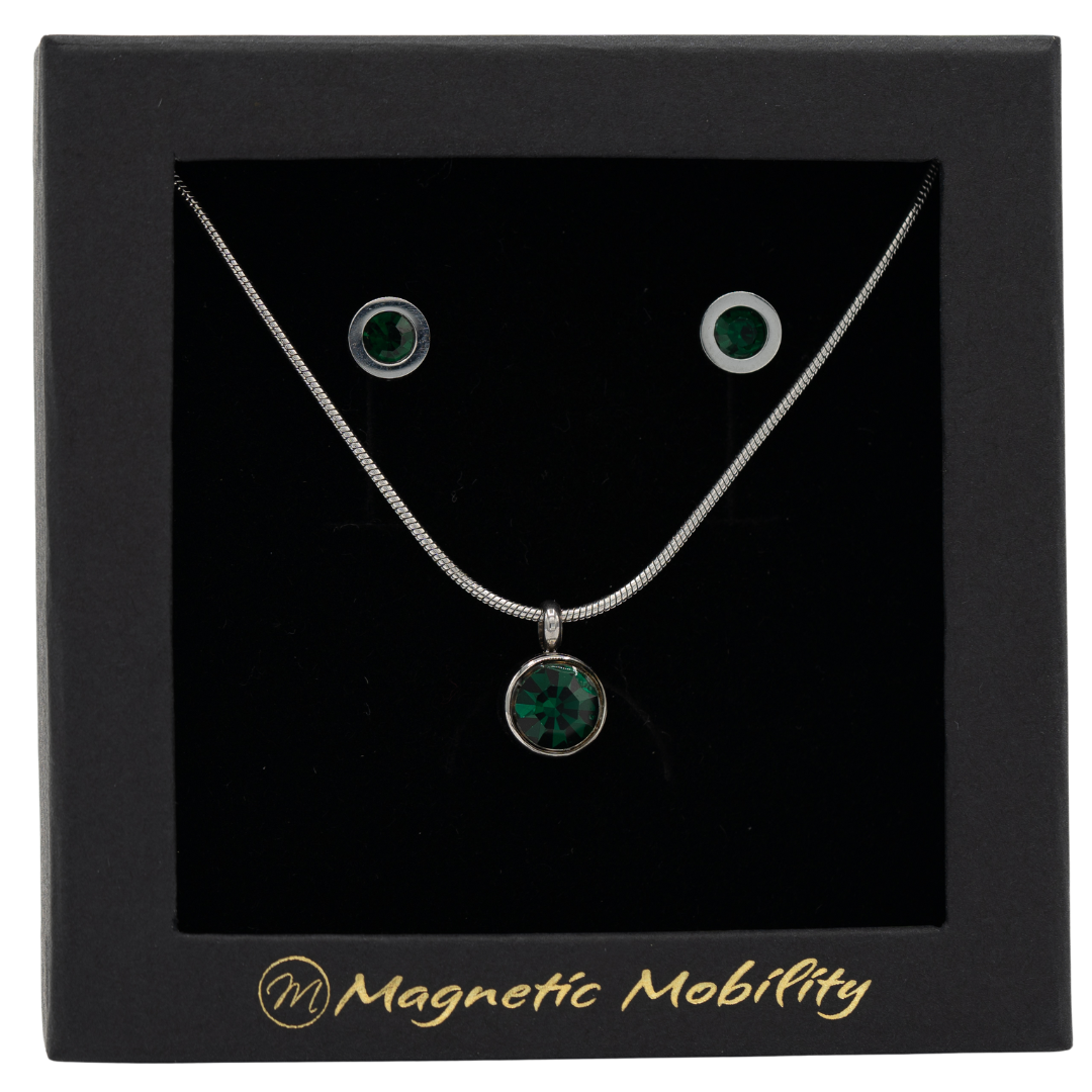 May Magnetic Mobility Birthstone Gift Set featuring a Magnetic Necklace and Stud Earrings featuring emerald green Swarovski crystals, elegantly presented in a black box with Magnetic Mobility branding. These magnetic back earrings offer stylish pain relief.