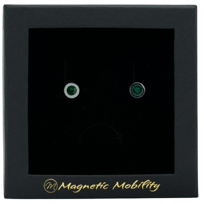 Magnetic Mobility May Birthstone Stud Earrings featuring emerald green Swarovski crystals, elegantly presented in a black box with Magnetic Mobility branding. These magnetic back earrings offer stylish pain relief.