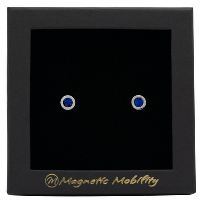 Magnetic Mobility September Birthstone Stud Earrings featuring saphire blue Swarovski crystals, elegantly presented in a black box with Magnetic Mobility branding. These magnetic back earrings offer stylish pain relief.